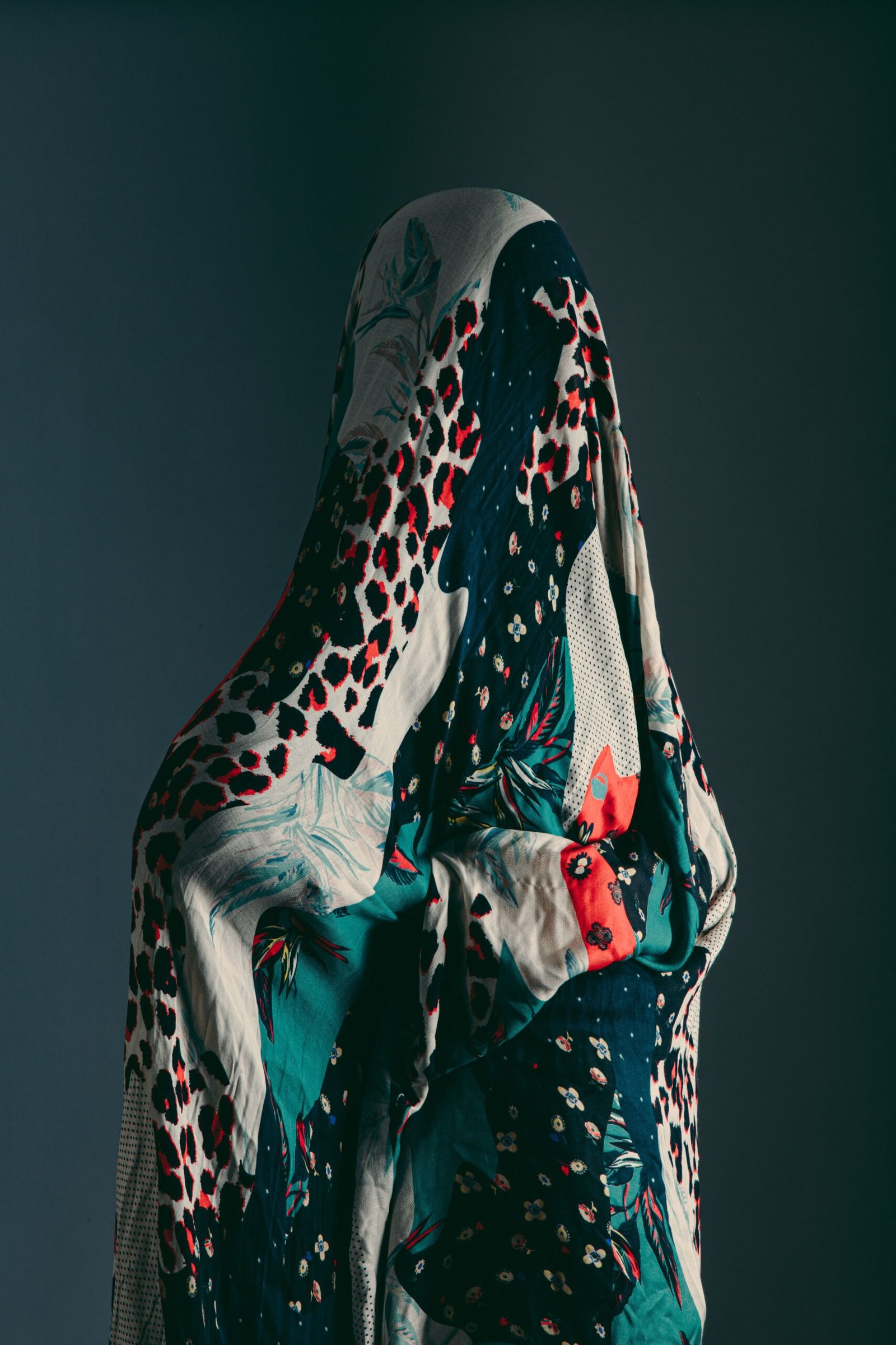 beautiful vertical shot of a person covered in a scarf with different patterns